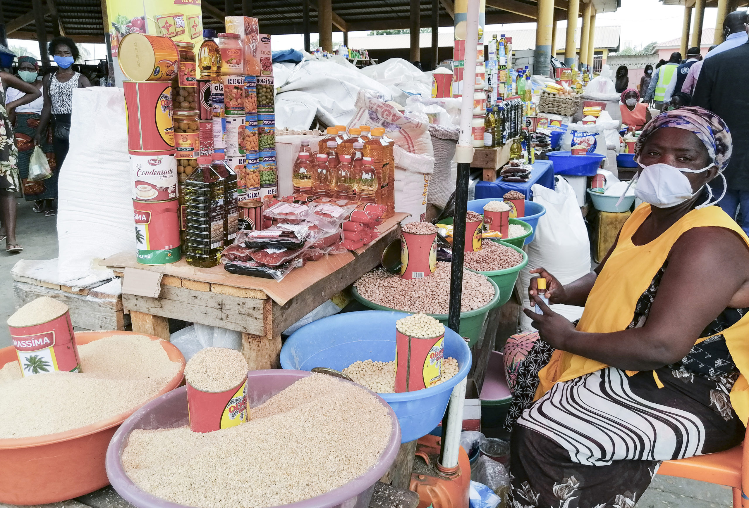 Sellers wearing protective face masks stand at their stall at the Asa Branca Market.